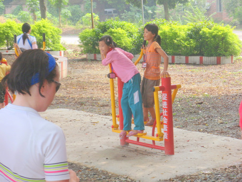 Two girls playing at the playground.